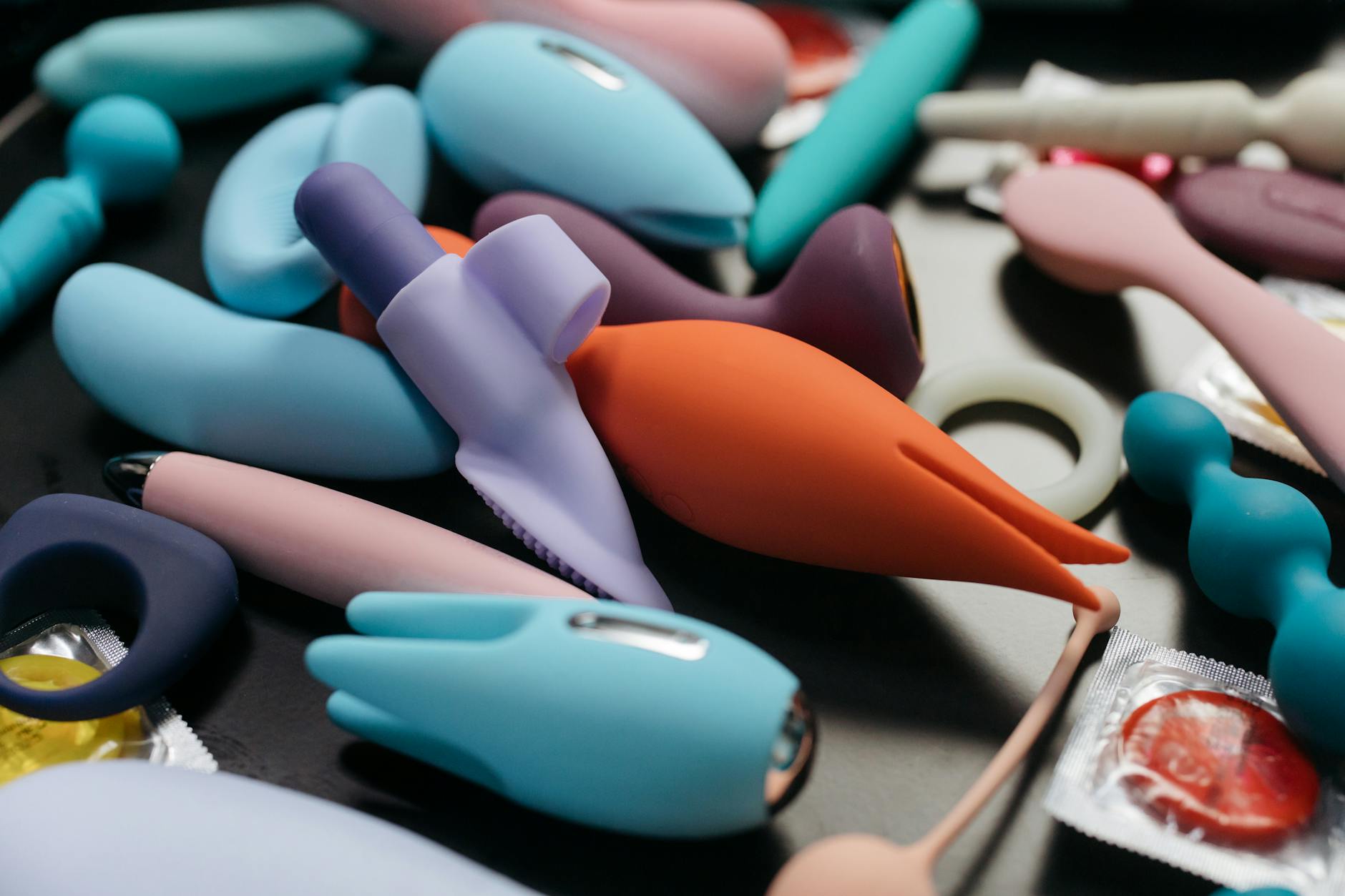 Array of colorful vibrators including lemon clitoral vibrators displayed in a close-up view