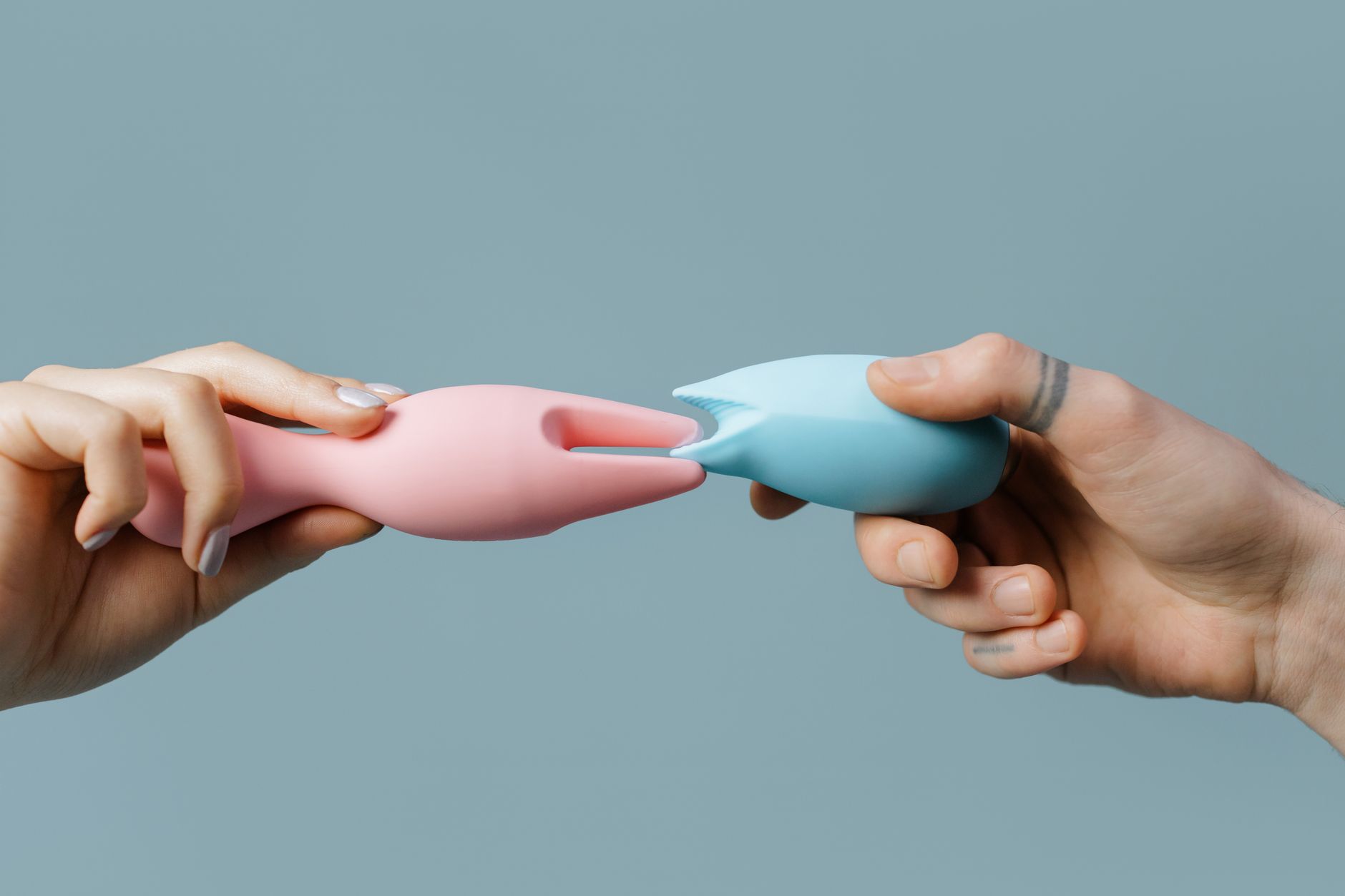 Hands holding a personal massager, representing tactile pleasure recovery after medication changes