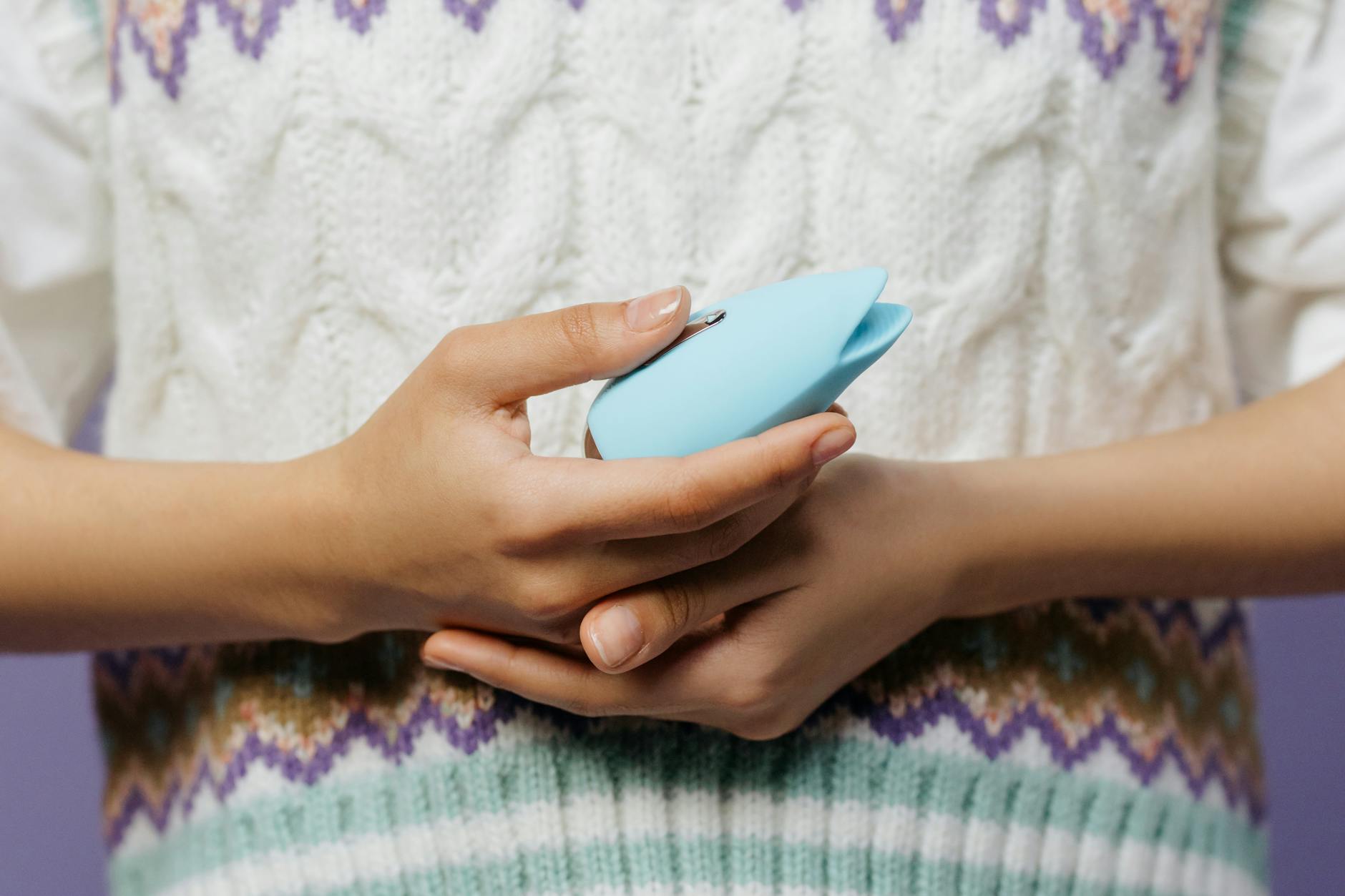 Close-up of hands holding a lemon vibrator, emphasizing personal pleasure and self-connection