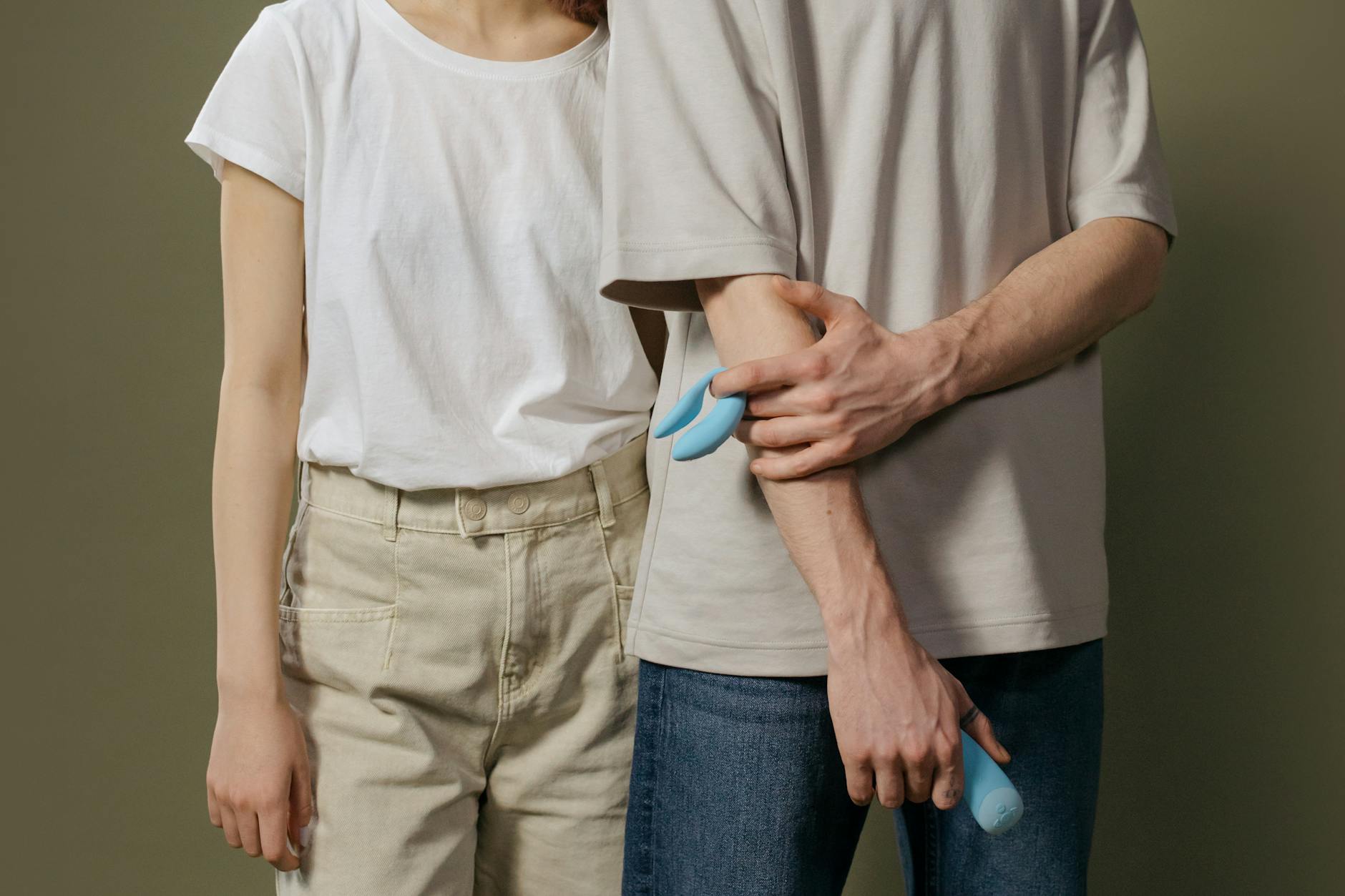 A couple exploring pleasure together with a vibrator, representing modern intimacy during physical transitions