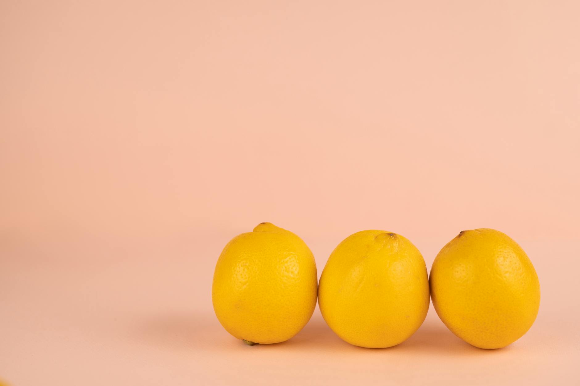 Bright yellow lemons arranged on a pastel background, symbolizing fresh sensation and restored vitality